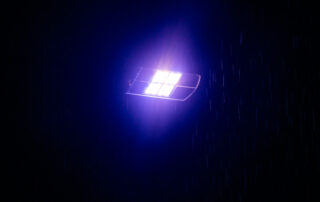 A close up shot of an LED streetlight that has turned purple